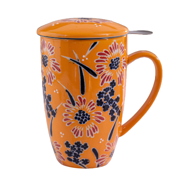 Orange mug with floral pattern and spoon on a white background. The Spice & tea Shoppe