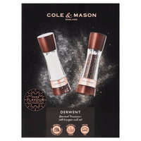 A pair of Cole & Mason Derwent salt and pepper mills featuring dark wood tops and bases with rose gold accents.