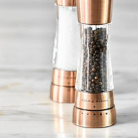 A pair of Cole & Mason Derwent salt and pepper mills in a metallic copper finish.