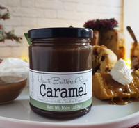 Jar of Haute Buttered Rye Caramel sauce on a plate with waffles and whipped cream. The Spice & Tea Shoppe