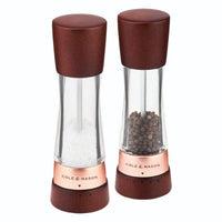 A pair of Cole & Mason Derwent salt and pepper mills featuring dark wood tops and bases with rose gold accents.