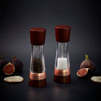 A pair of Cole & Mason Derwent salt and pepper mills featuring dark wood tops and bases with rose gold accents.