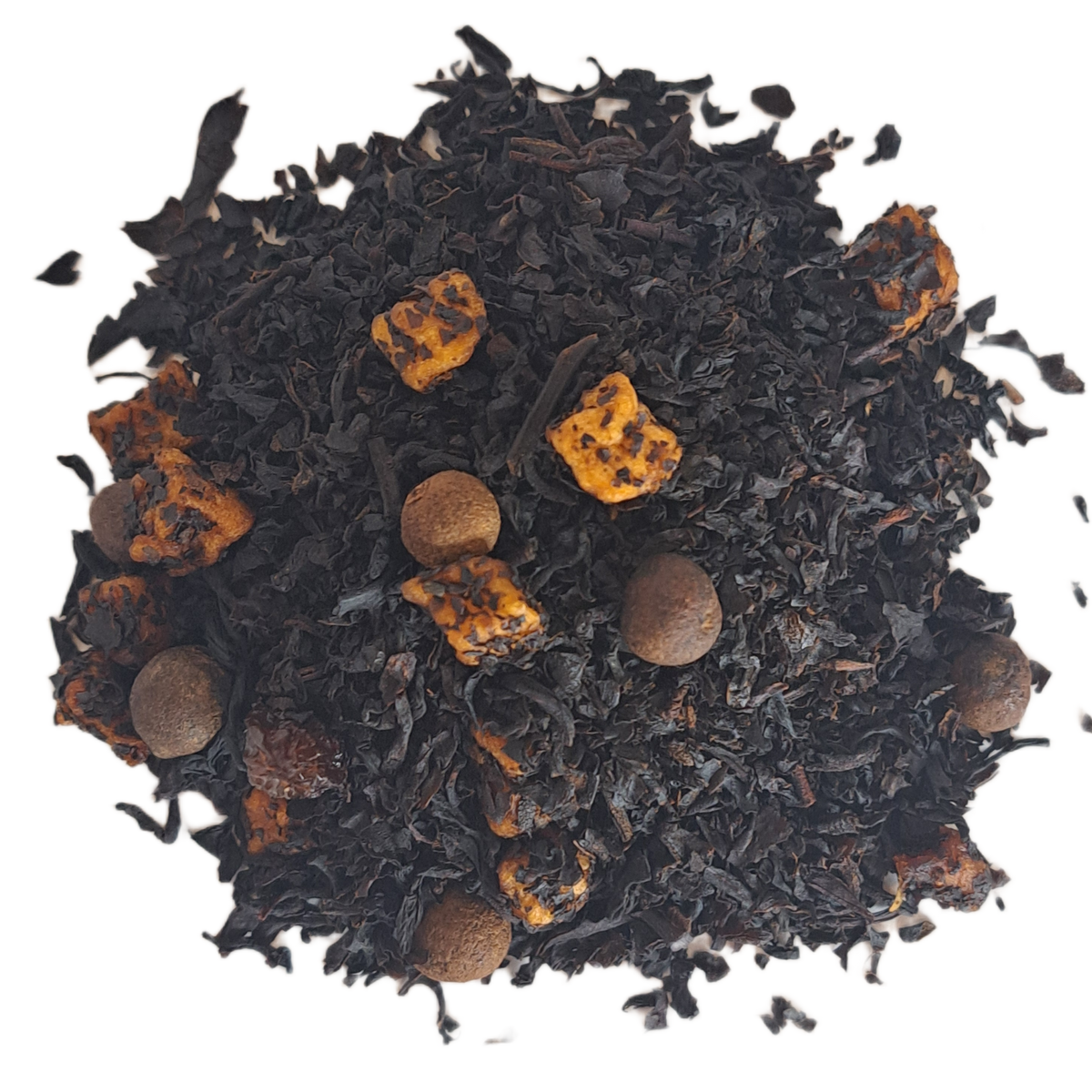 Black tea leaves with orange peel and nuts on a white background_ Caramel Spiced Rum Black Holiday Tea_ The Spice & Tea Shoppe