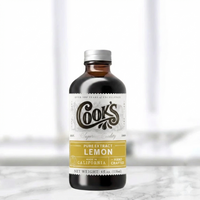 Bottle of Cook's Pure Extract Lemon on a white background