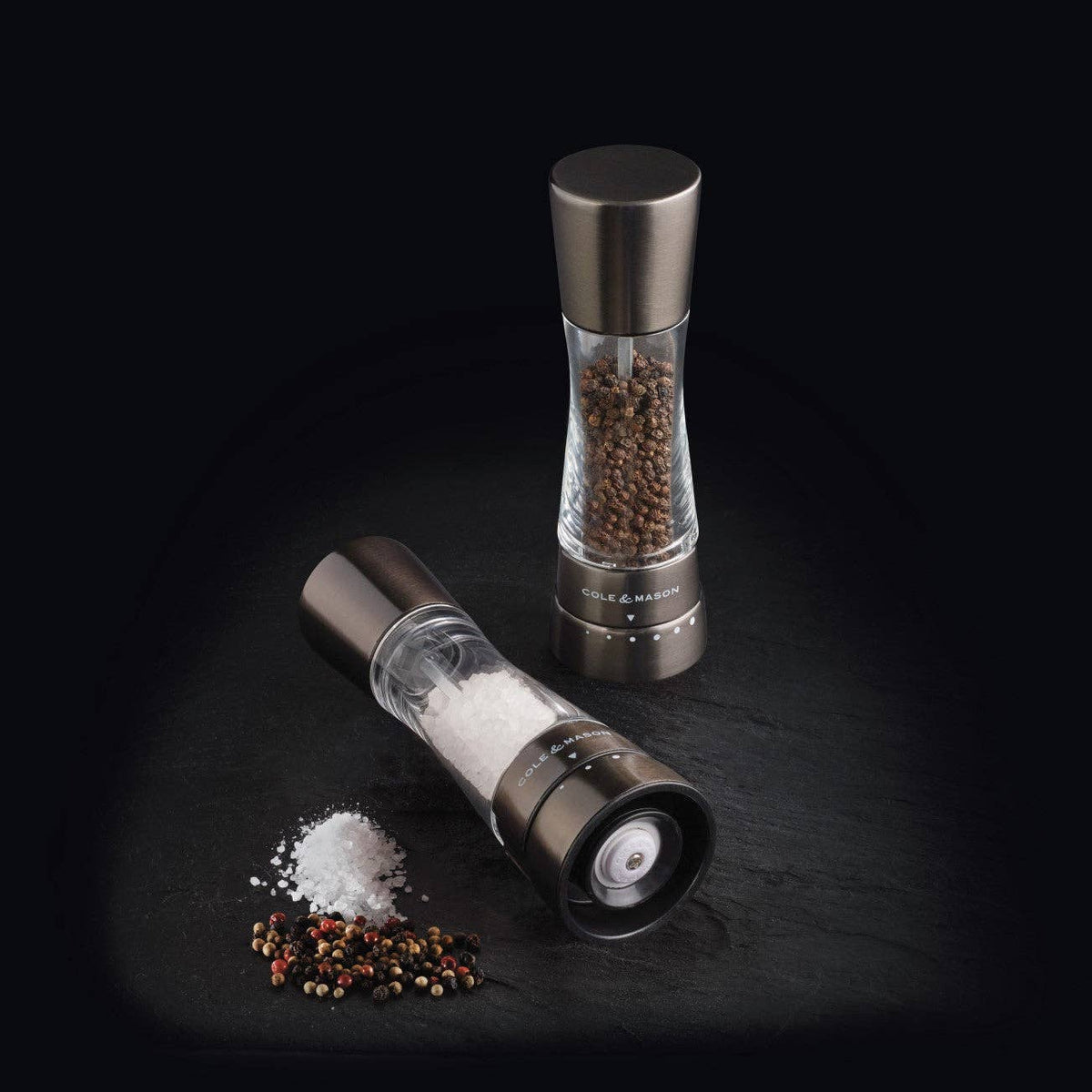 A pair of Cole & Mason Derwent salt and pepper mills in a sleek, gunmetal grey finish.